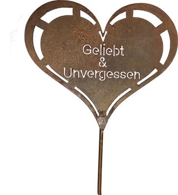 A rusty metal heart-shaped garden stake with text.