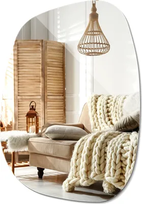 A cozy living room scene with a sofa, blankets, and a folding screen.