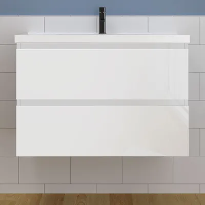A white bathroom vanity with two drawers is mounted on a tiled wall.
