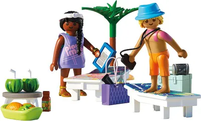 Two Playmobil figures on a beach with loungers, drinks, and accessories.