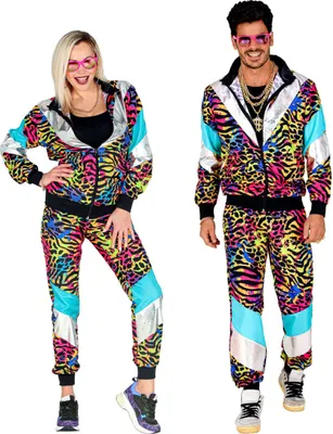 A man and a woman posing in matching colorful 80s-style tracksuits.