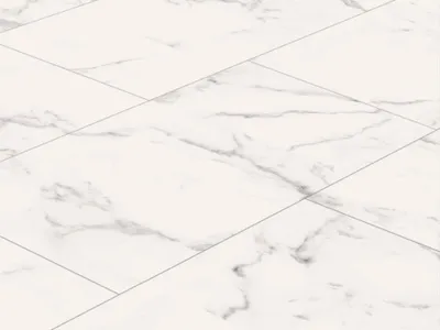 A close-up, angled view of white marble-patterned vinyl flooring tiles.