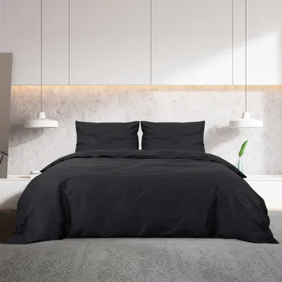 A black duvet cover set is displayed on a bed in a modern bedroom setting.