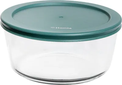 A clear, studio shot of a round glass food storage container with a green lid.