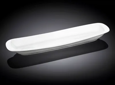A white ceramic serving dish on a dark background.