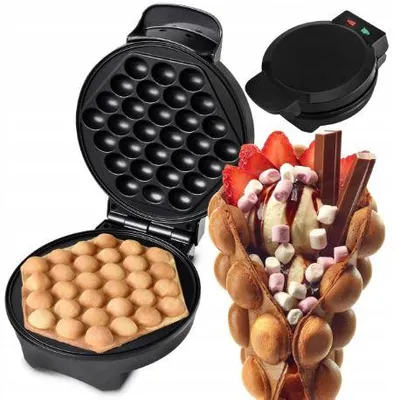 A waffle maker and a bubble waffle cone filled with ice cream and toppings.