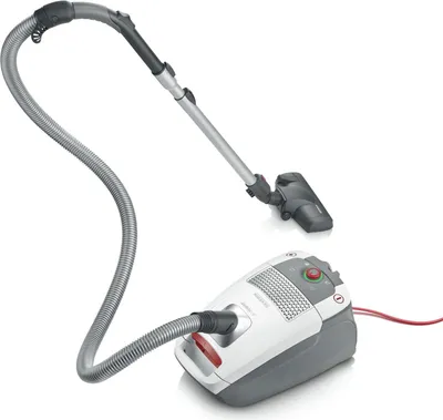 A vacuum cleaner and its hose and nozzle, isolated on a white background.