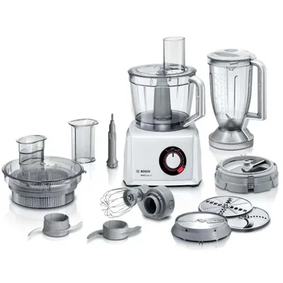 A white Bosch food processor with various attachments and a blender jug, all displayed on a white background.