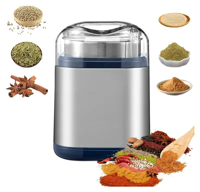 A spice grinder surrounded by various spices and herbs.