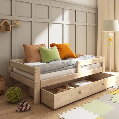 A child's bed with a trundle drawer pulled out, showing pillows and a toy.
