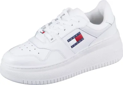A white Tommy Hilfiger leather sneaker with a platform sole is shown against a white background.