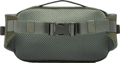 The back of a green fanny pack with a mesh panel and a buckle closure.