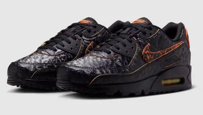 A pair of black Nike Air Max 90 sneakers with orange accents and a textured pattern.