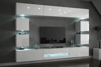 A modern white living room wall unit with a television and integrated LED lighting.