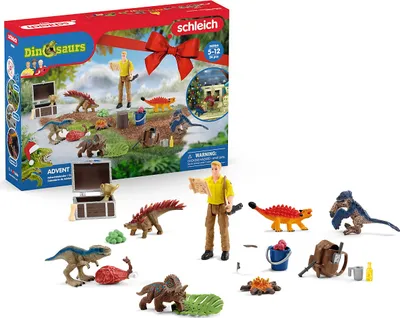 A Schleich Dinosaurs Advent Calendar 2023 with various dinosaur figures and accessories laid out in front of the box.