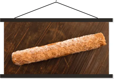 Produktbild von MuchoWow® Textilposter Ein gefrorener Frikandel auf einem Holztisch 150x75 cm mit schwarzem Rahmen - Posterleiste