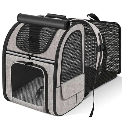 A gray and black expandable pet carrier with mesh windows and pockets.