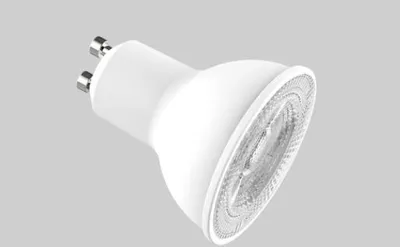 A white LED light bulb with a GU10 base is shown against a plain gray background.