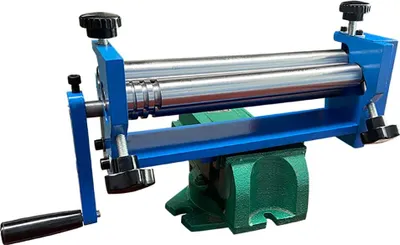 A manual metal bending machine is clamped to a green vise against a white background.