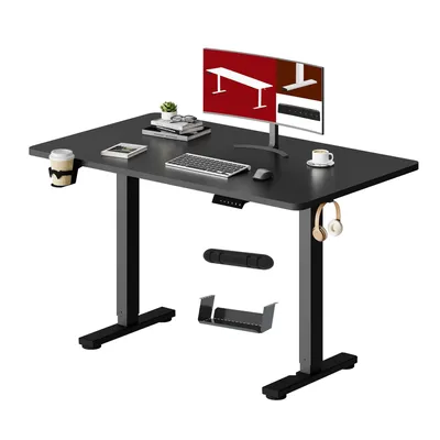 A black adjustable standing desk with a monitor, keyboard, mouse, and accessories.