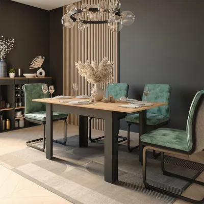A dining room with a table and chairs set up for a meal.