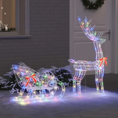 Christmas decorations in the snow outside a house.