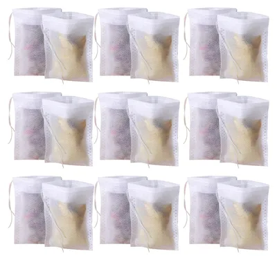 A grid of tea filter bags, some filled with golden material and others with purple material.