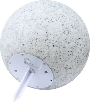 The underside of a solar-powered garden light shaped like a sphere with a speckled stone-like texture.