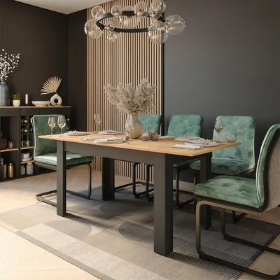 A dining room with a table and chairs set up for a meal.