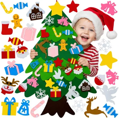 A child wearing a Santa hat is smiling and holding a felt Christmas tree with various felt ornaments.