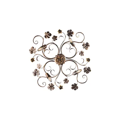 A decorative metal wall art piece with floral and vine motifs.