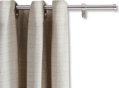 A close-up view of a silver curtain rod with beige curtains hanging from it.