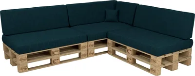 A sectional sofa made from wooden pallets with dark green cushions.