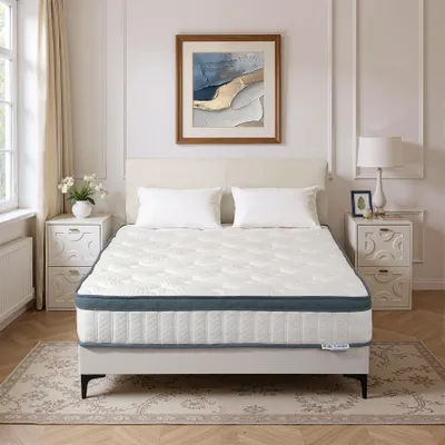 A mattress is displayed on a bed frame in a bedroom setting.