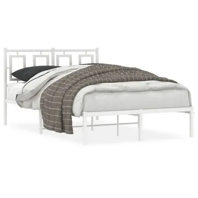 A white metal bed frame with a mattress and bedding.