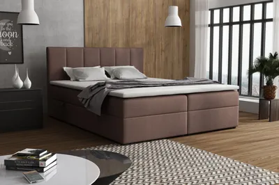 A bedroom scene with a bed, nightstand, and a rug.