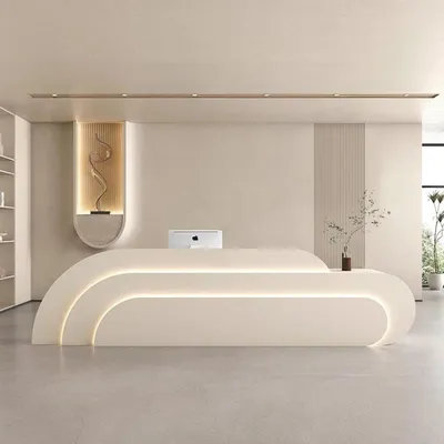 A modern reception desk in a clean, minimalist interior.