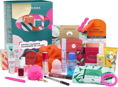 A collection of beauty products, including skincare, makeup, and accessories, arranged around a Sephora advent calendar.