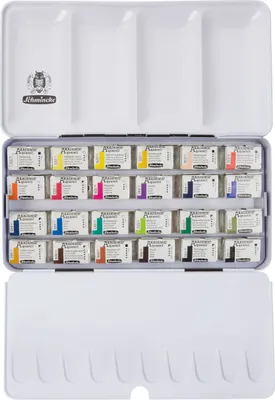 An open metal tin containing watercolor paint pans, with the lid open and showing mixing wells.