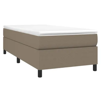 A single taupe boxspring bed with a white mattress on a white background.