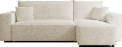 A cream-colored sectional sofa with a textured bouclé fabric.