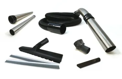 A collection of vacuum cleaner attachments and a hose are laid out on a white background.