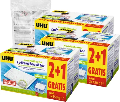 Multiple boxes of UHU air dehumidifier refill bags stacked together, with one bag of refills in the background.