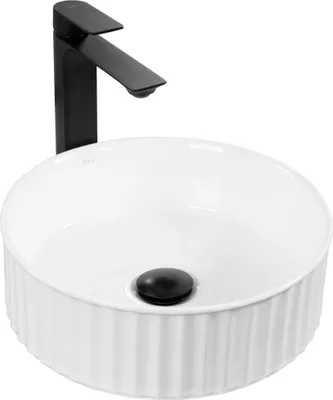 A white ceramic washbasin with a black faucet.