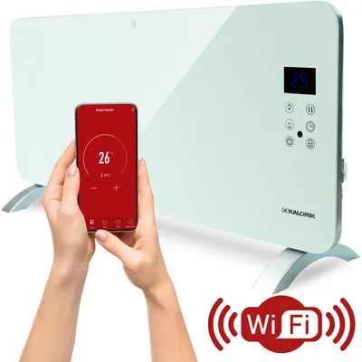 A person is holding a smartphone displaying a heating app, in front of a white electric panel heater with a digital display and controls.
