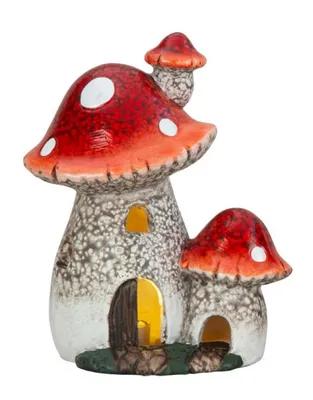 Fantasievolles Pilzhaus aus Polyresin, mit LED-Beleuchtung. Hut ist leuchtend mit weißen Punkten.