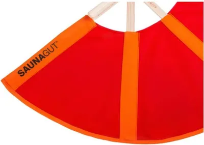 A close-up of a red and orange fan-like object with wooden handles.