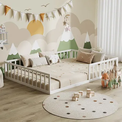 A child's bedroom with a floor bed, decorated with a mountain mural and playful accessories.