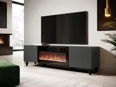 A modern living room with a TV stand featuring an electric fireplace, a large television, and a fireplace in the background.