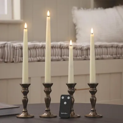 Immagine prodotto di TruGlow, set di 4 candele a punta in vera cera, luce bianco caldo, LED lampeggianti, con telecomando e timer, alimentate a batteria